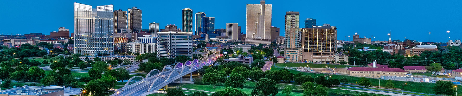 header image for the markets we serve page. Its a skyline of a large city with skyscrapers and bridges